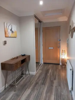 a hallway with a desk and a door at Idyllic Waterside Penthouse in Callander