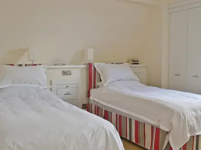two beds sitting next to each other in a bedroom at Waterside in Tighnabruaich