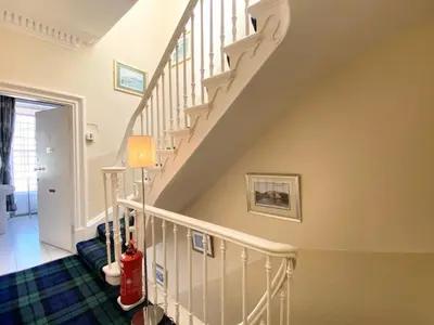 a staircase with white railings in a home at Daviot Guest House in Ayr