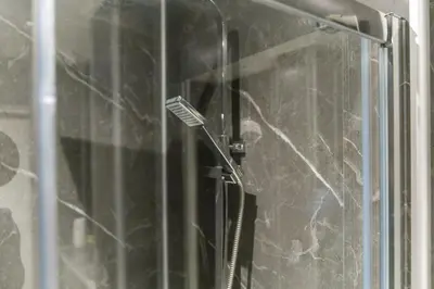 a close up of a glass door of a shower at Upper Grove 2 Bedroom Apartment - Edinburgh in Edinburgh