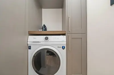 a washer and dryer in a small room at Upper Grove 2 Bedroom Apartment - Edinburgh in Edinburgh