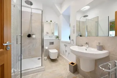 a bathroom with a sink and a shower and a toilet at 20 The Courtyard, Ballochmyle House in Mauchline