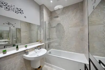 a bathroom with a sink and a tub and a toilet at 20 The Courtyard, Ballochmyle House in Mauchline