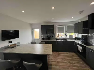 a kitchen with a large island in the middle at Ardenslate House in Kirn