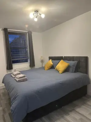 a bedroom with a large bed with yellow pillows at Edinburgh Lauriston 4 bedroom 7 beds duplex in Edinburgh