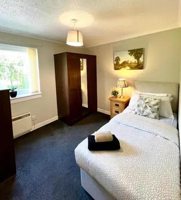 a bedroom with two beds and a window at Spacious 2 Bed-Flat in Glasgow City - Free Parking in Glasgow
