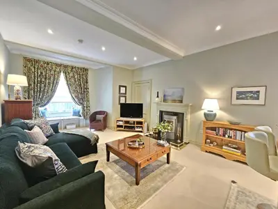 a living room with a couch and a table at Edinburgh Elegant 1-Bedroom City Apartment in Edinburgh