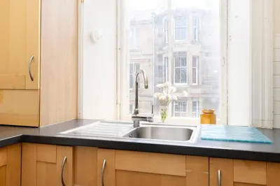 a kitchen with a sink and a window at Charming 1-Bedroom Edinburgh City Getaway in Edinburgh
