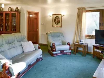 a living room with two couches and a tv at The Wheelhouse in Linlithgow