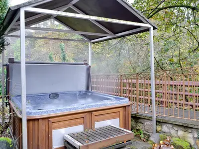 a hot tub sitting under a gazebo at The Wheelhouse in Linlithgow