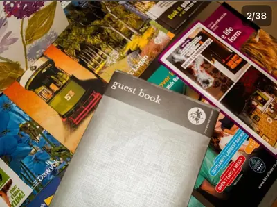 a close up of a guest book and other items at HLA king court 3 in Motherwell