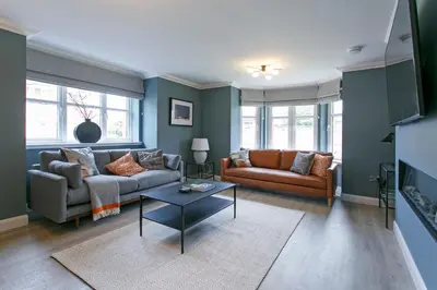 a living room with two couches and a table at Troon No 1 Apartments in Troon