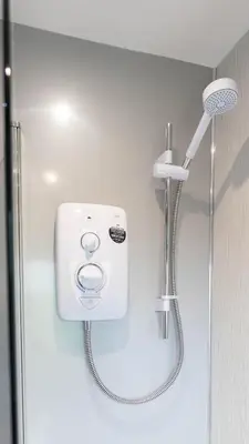 a shower in a bathroom with a shower head at Campsie View in Glasgow