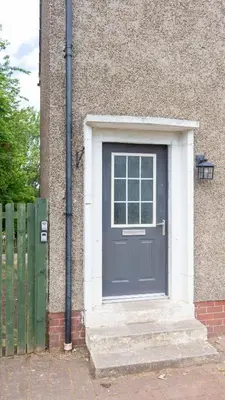 a blue door on the side of a building at Campsie View in Glasgow