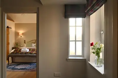 a bedroom with a bed and a window at The Old Farmhouse in Buchanty