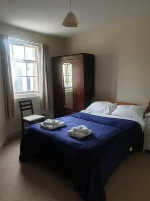 a bedroom with a bed with two towels on it at Rose Street 2 bedroom in Edinburgh
