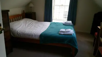 a bedroom with a bed with towels on it at Rose Street 4 bedroom in Edinburgh
