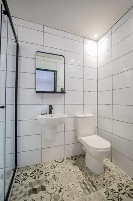 a bathroom with a toilet and a sink and a mirror at The Righ in Oban