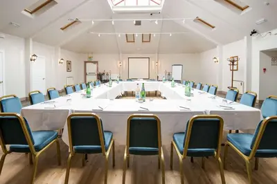 a large conference room with a large white table and chairs at The Inveraray Inn, BW Signature Collection in Inveraray