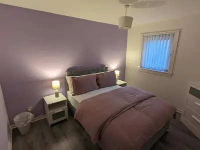 a small bedroom with a bed and a window at 4 bedroom Townhouse Greenock in Greenock