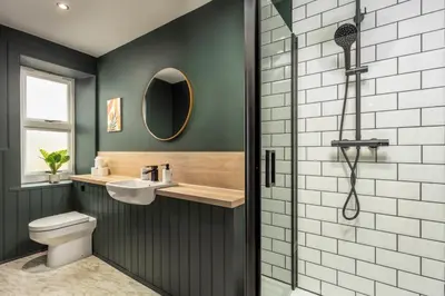 a bathroom with a shower and a toilet and a sink at Wellington Lodge in Ayr