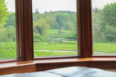 a window looking out at a view of a field at The Farmhouse at Solsgirth Home Farm in Dollar
