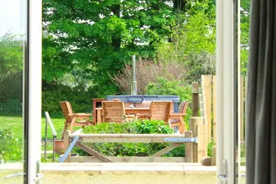 a table and chairs in a yard with a table at The Farmhouse at Solsgirth Home Farm in Dollar