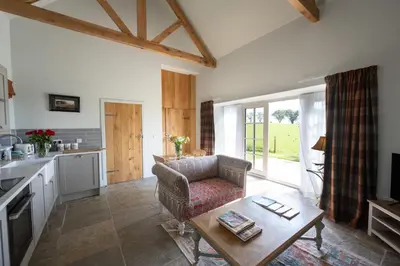 a living room with a couch and a table at The Bothy in Buchanty