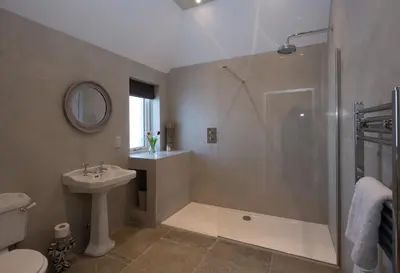 a bathroom with a shower and a toilet and a sink at Milton Farm in Buchanty