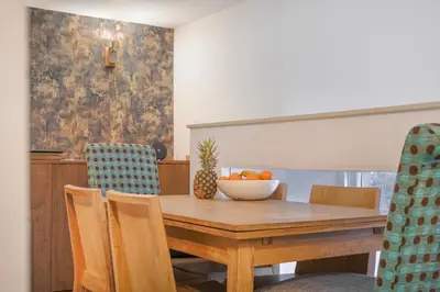 a dining room table with a bowl of fruit on it at The Old School in Dean Village in Edinburgh