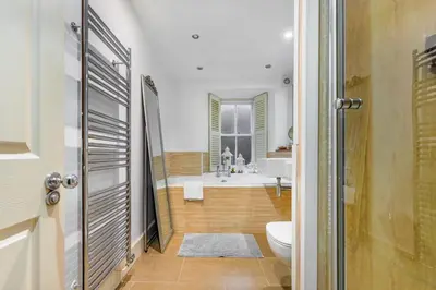 a bathroom with a tub and a toilet and a sink at The Old School in Dean Village in Edinburgh