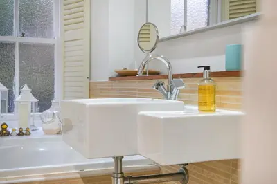 a bathroom with a white sink and a mirror at The Old School in Dean Village in Edinburgh