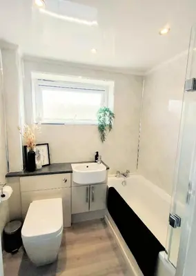 a bathroom with a toilet and a sink and a tub at Troon Beach and Golf House in Barassie