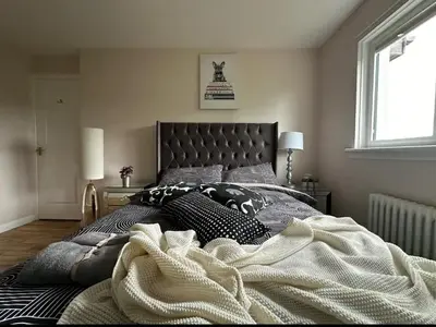 a bed with a blanket on it in a bedroom at Beautiful house in Clydebank in Glasgow
