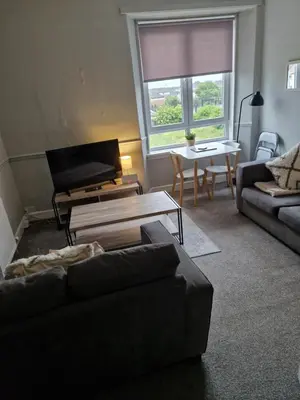 a living room with a couch and a table at Star Apartment in Dumbarton
