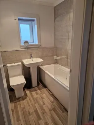 a bathroom with a sink and a toilet and a bath tub at Star Apartment in Dumbarton