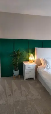 a bedroom with a bed and a table with a potted plant at Troon Golf and Beach House in Troon