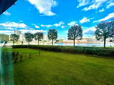 a park with a green field and a river at Cosy Riverside Home SECC Hydro in Glasgow