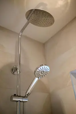 a shower with a shower head in a bathroom at Cosy & Comfortable 2BR in Oban - Walk to Waterfront in Oban