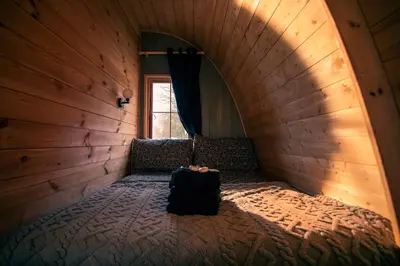 a room with a chair and a suitcase on the floor at Green Oak Nature Retreat in Dunfermline