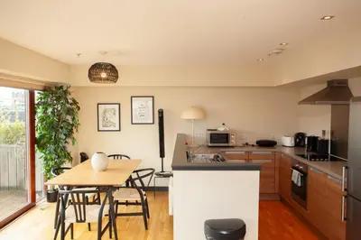 a kitchen and dining room with a table and chairs at Beautiful Penthouse in City Centre Location in Glasgow