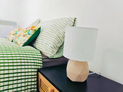 a lamp on a table next to a bed at La Casita, Quarry - 2 bedroom Entire Apartment with Free Parking in Glasgow