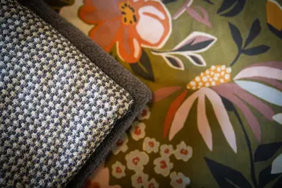 a close up of the corner of a pillow with flowers at 2Bed City Central East End Gem with Free Parking in Glasgow