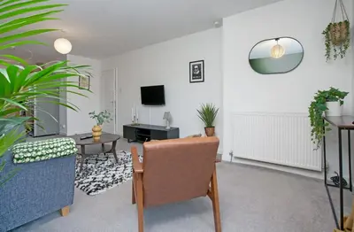 a living room with a couch and a table at 2Bed City Central East End Gem with Free Parking in Glasgow