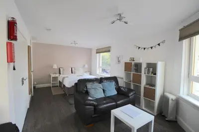 a living room with a couch and a bed at Lochrin Apartments by Edinburgh City Apartments in Edinburgh