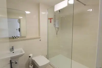 a bathroom with a shower and a toilet and a sink at Lochrin Apartments by Edinburgh City Apartments in Edinburgh