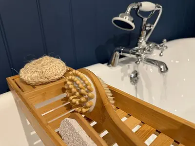 a wooden basket next to a bath tub with a sink at Stylish House with hot tub in Dalry