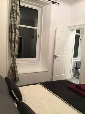 a bedroom with a window and a bed and a windowvisor at Beautiful 2 double bedrooms, 2 baths apartment in Port Glasgow