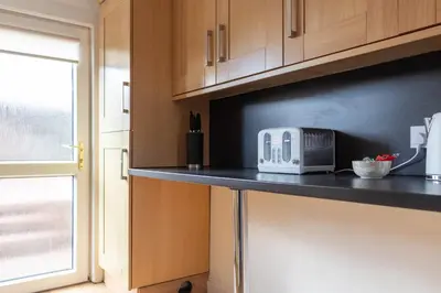 a kitchen with a counter with a toaster on it at Beth House in Bathgate