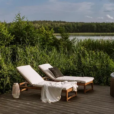 two lounge chairs on a deck near a body of water at BonnieClyde in Beattock